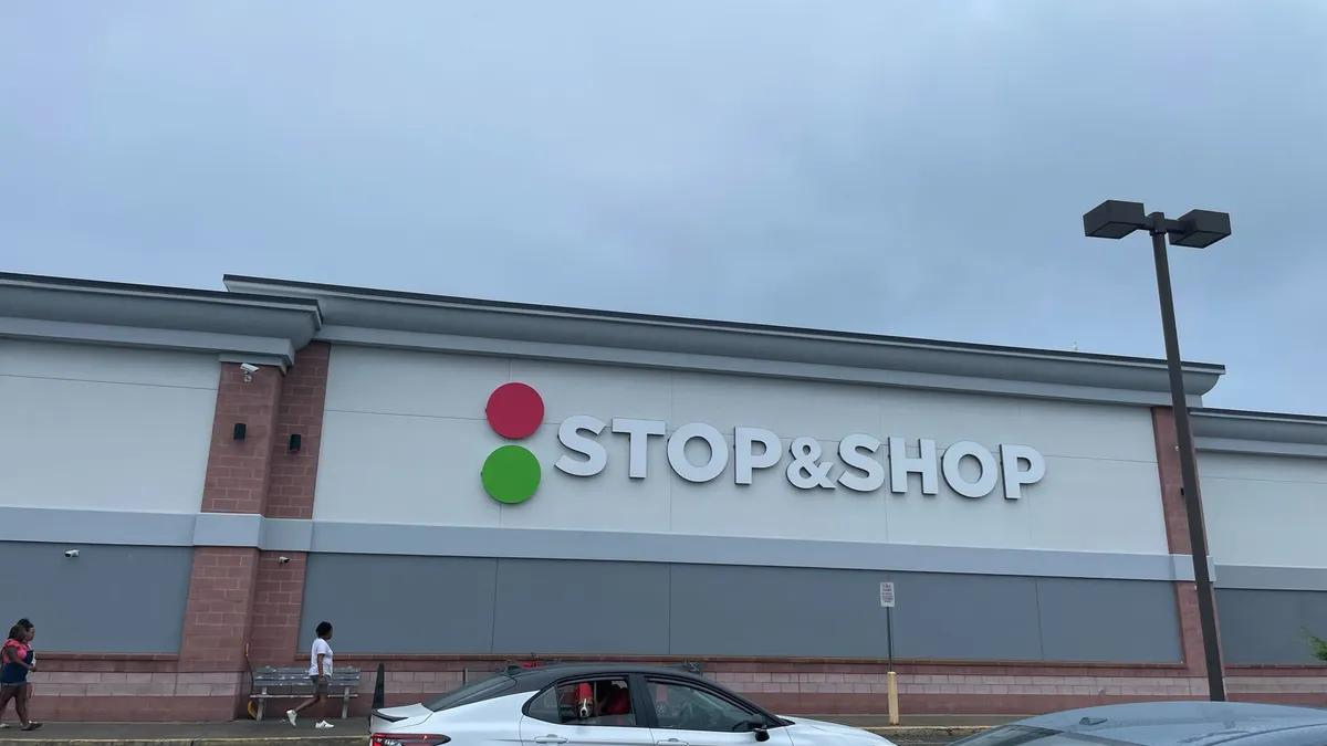 exterior of a grocery store upon which the words Stop and Shop can be seen