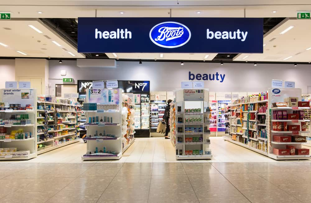 A photo of the interior a Boots store. Toiletries and medication are visible on the aisles