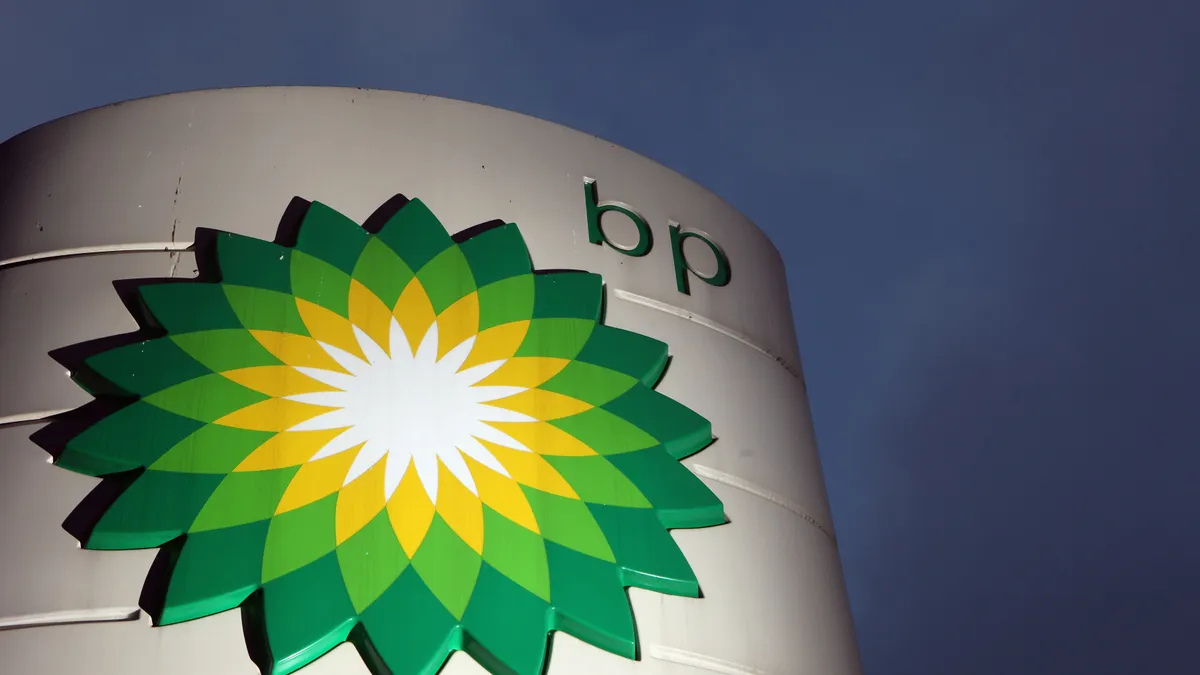 a photo of the BP logo on an external totem-style structure. The sky is dark