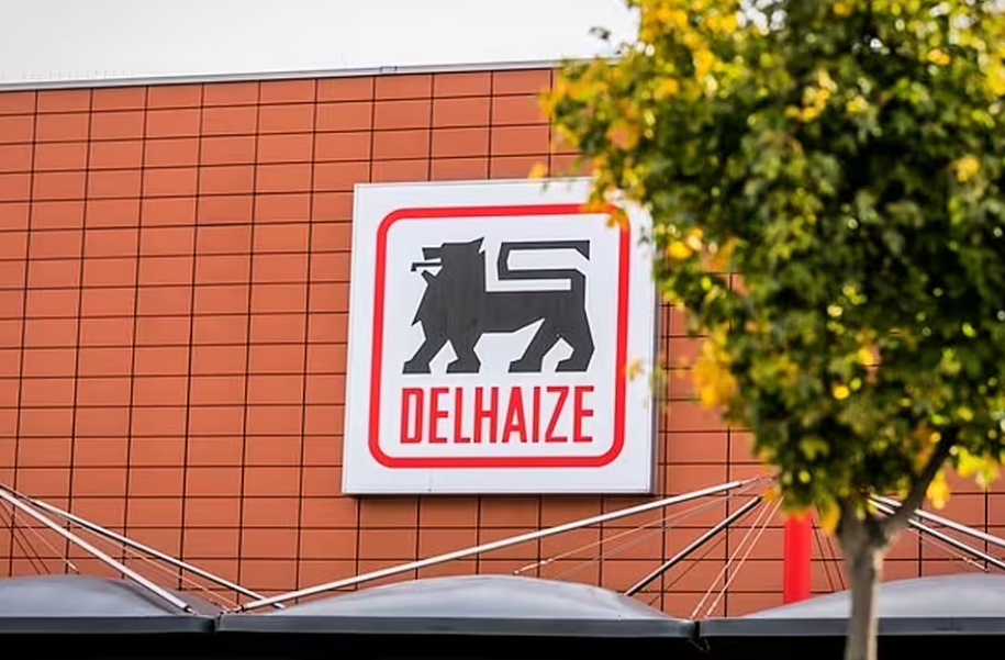 A photo of a Delhaize sign on the exterior of a building