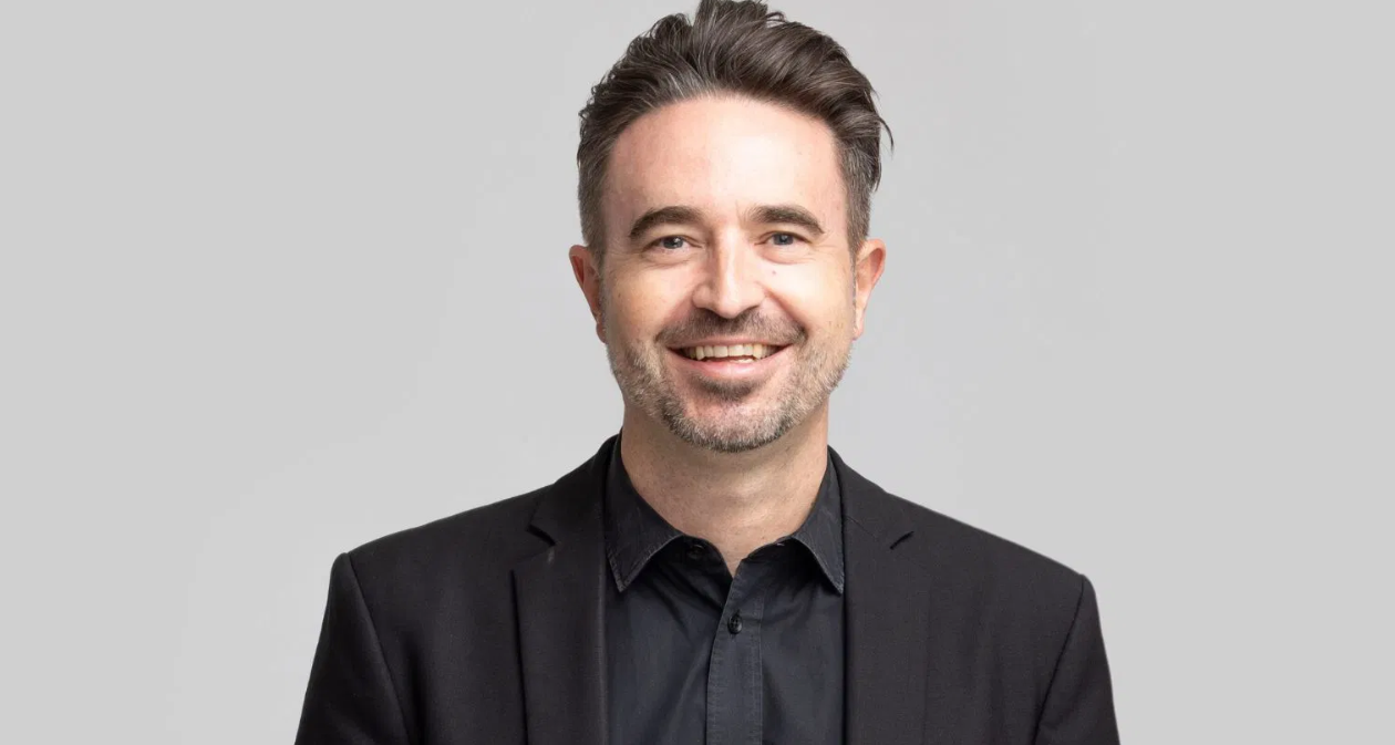 Neil Ackland, chief retail media officer at oOh!media smiles at the camera