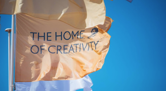 a flag flying that says the home of creativity