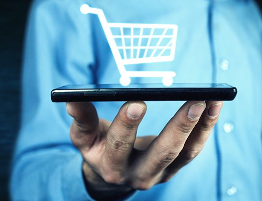 Man with phone and shopping cart symbol.