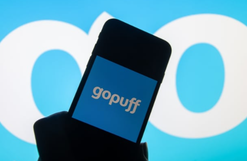 a photo of a cell phone on which the gopuff logo is visible