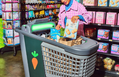 A colourful photo of a woman putting cereal into a shopping cart with the instacart carrot logo on it.