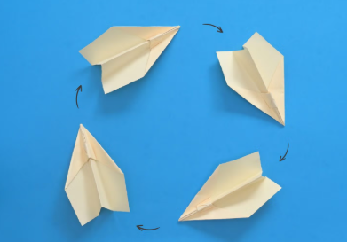 a photo of four paper planes arranged in a circle against a blue background
