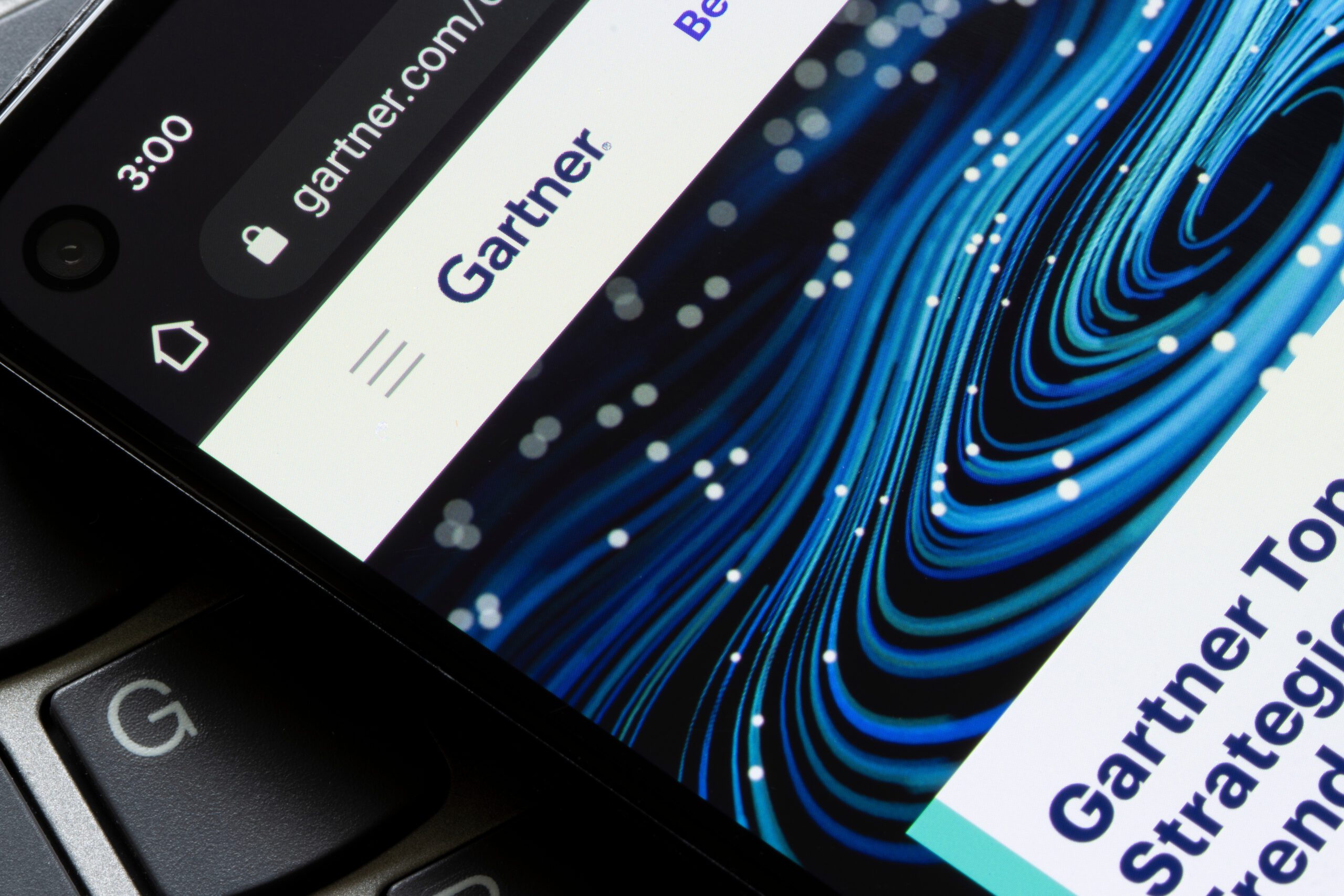 A keyboard with a screen resting on top showing the Gartner logo.