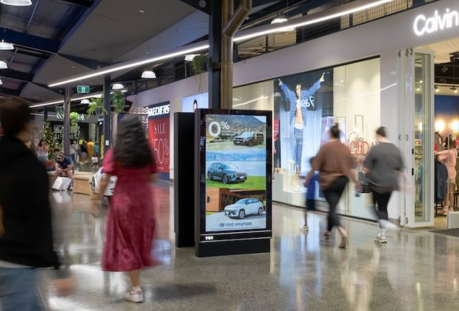 photograph of a screen totem in a shopping mall