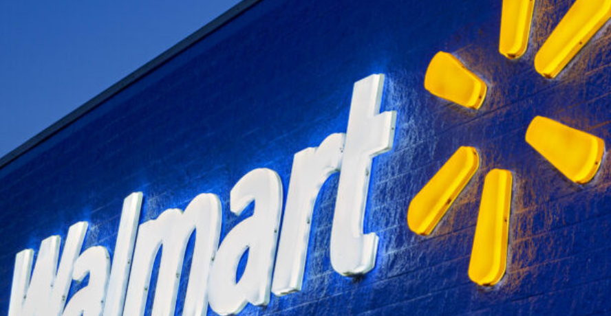 an illuminated Walmart logo on the side of a building