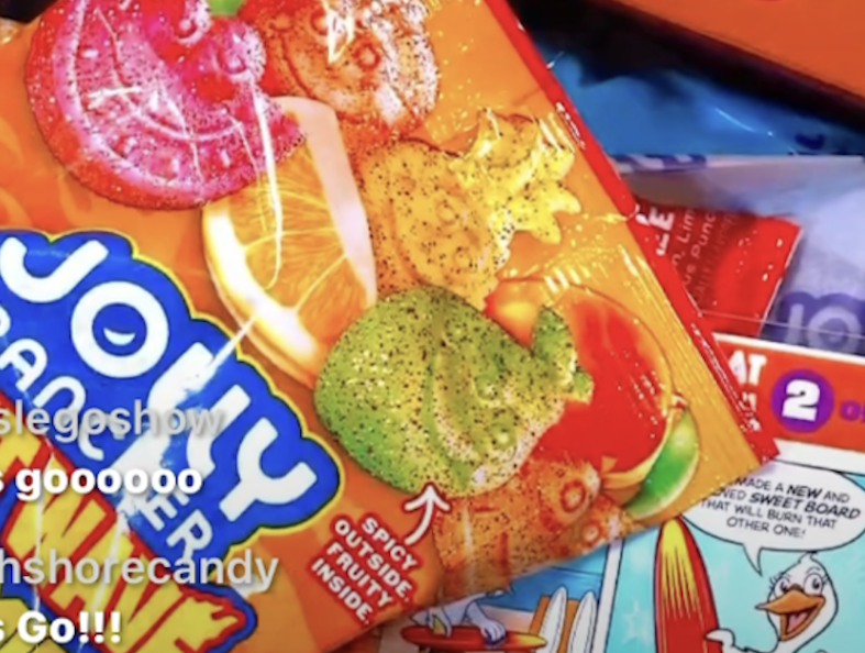 A photo of a jolly rancher packet upon which chat comments from social media can be seen.